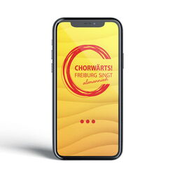 Auf einem Handybildschirm ist das Logo von „Chorwärts! – Freiburg singt alemannisch“ zu sehen